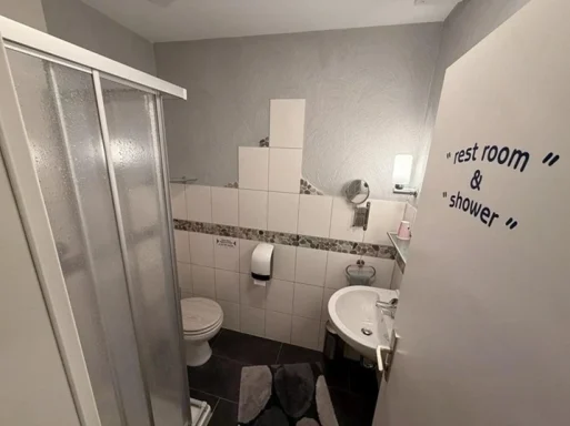Gepflegtes Badezimmer mit Dusche und WC in der Pension - Gästehaus Legden für Übernachtungsgäste.
